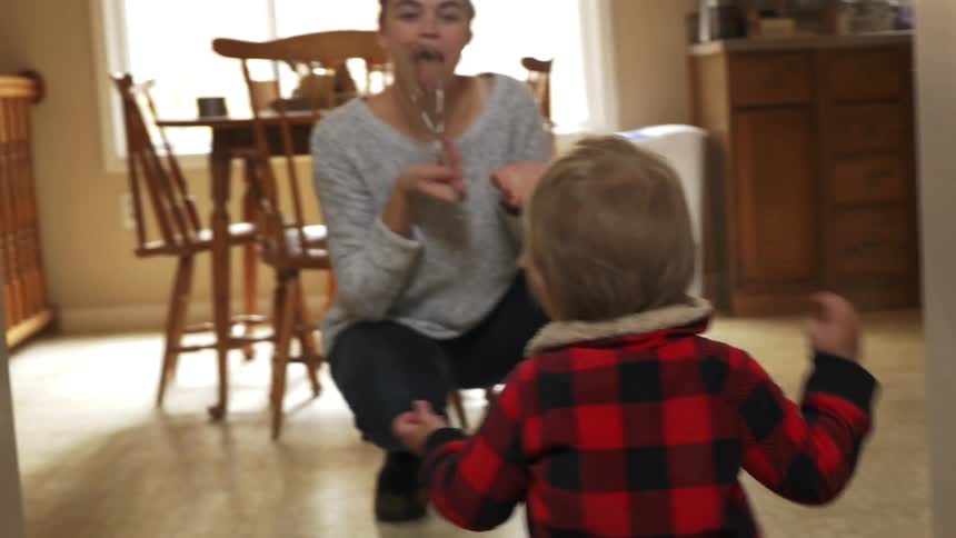 Toddler runs to an excited woman