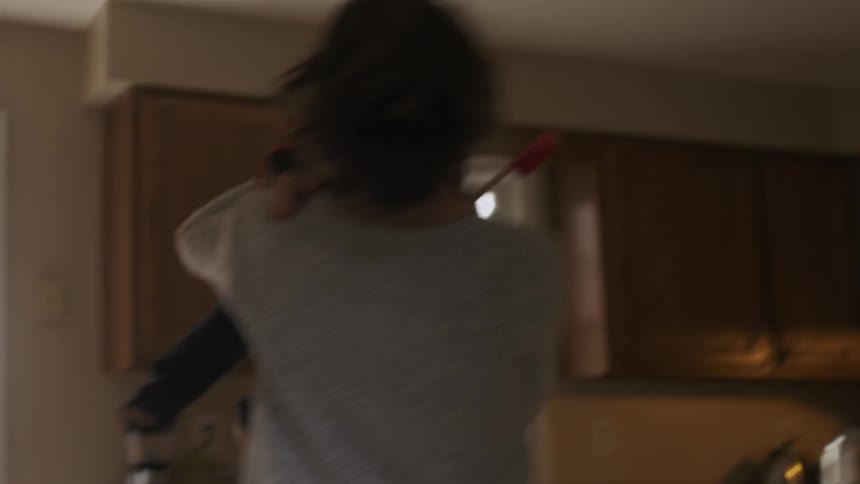 A woman twirls her baby around