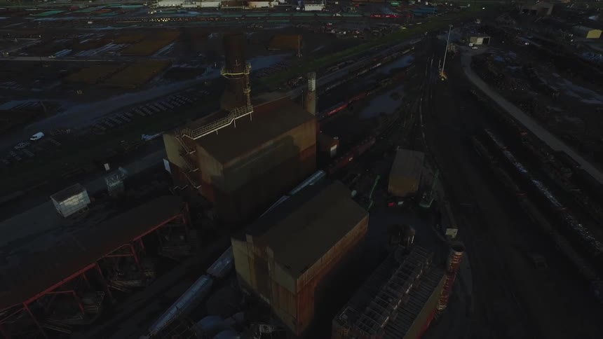 Trains sit in a grain depot during the day