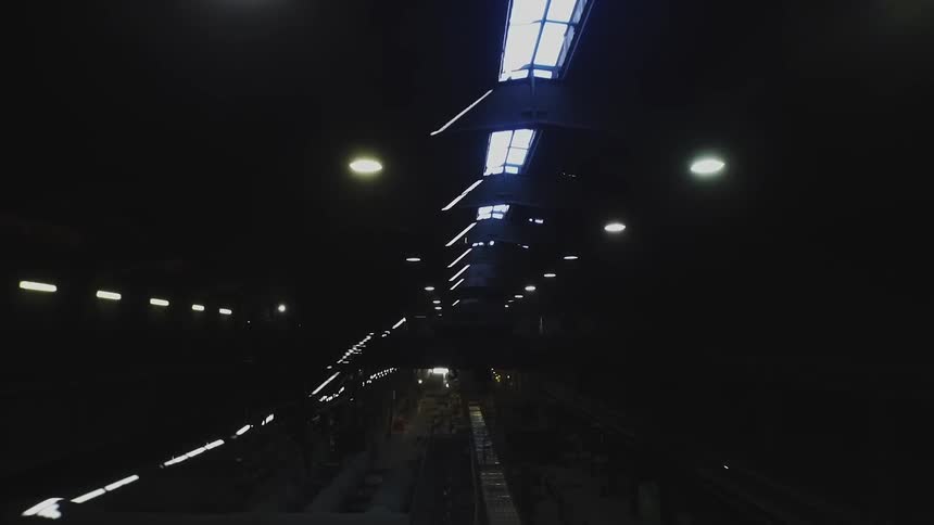 The tunnel is dark with some light coming in from the top