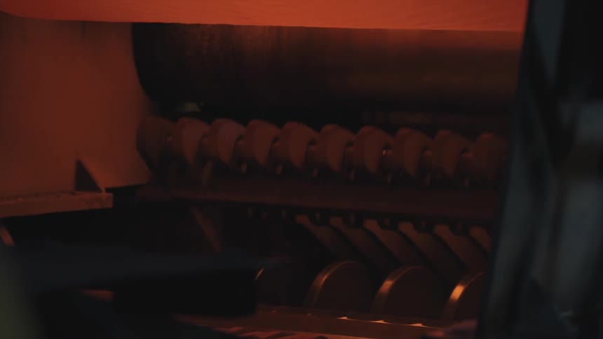 The machine moves up closing on a belt above