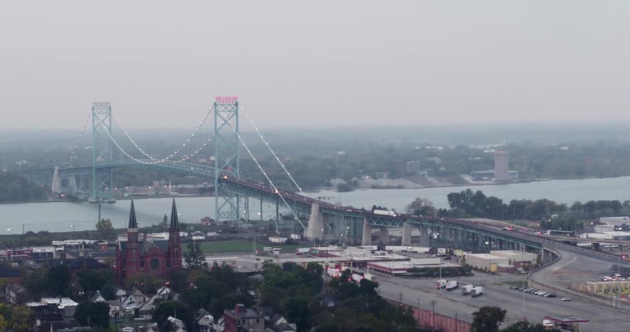 Cars travel on the large bridge by the town