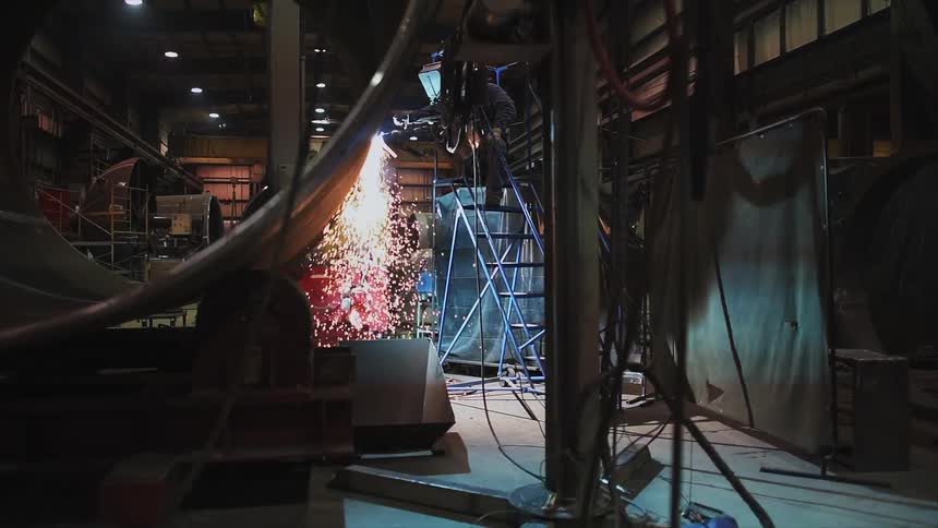 Shower of sparks rain down in a machine shop