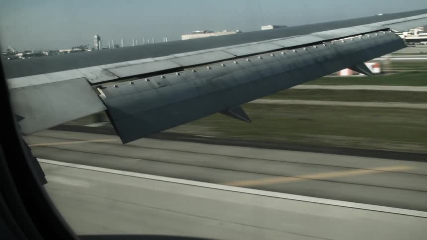 A plane is landing low on a runway