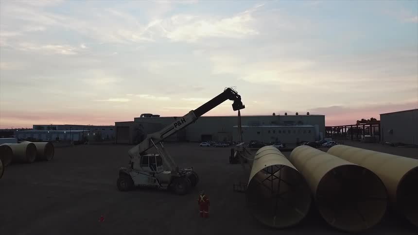 A crane is living a large tube