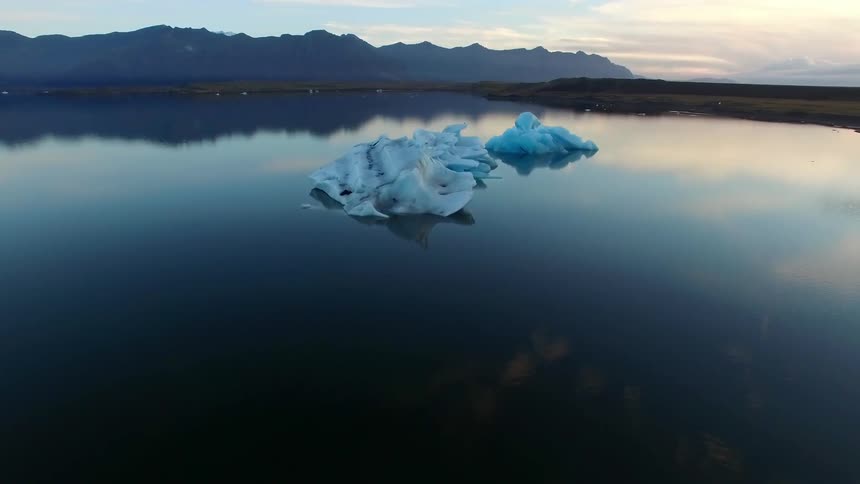 Light blue ice in the middle of a placid lake