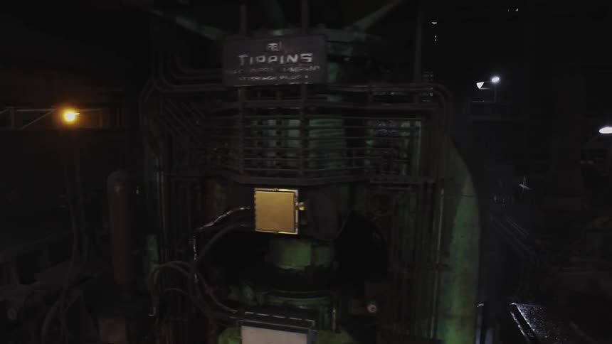 The dark warehouse is filled with machines