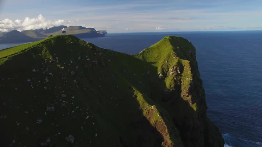 The ocean surrounds an island cliff