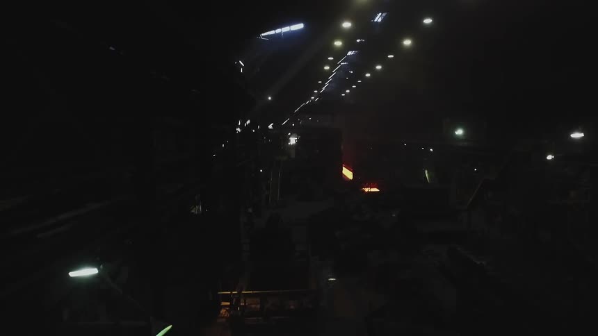 The tunnel is dark with lights lining the ceiling