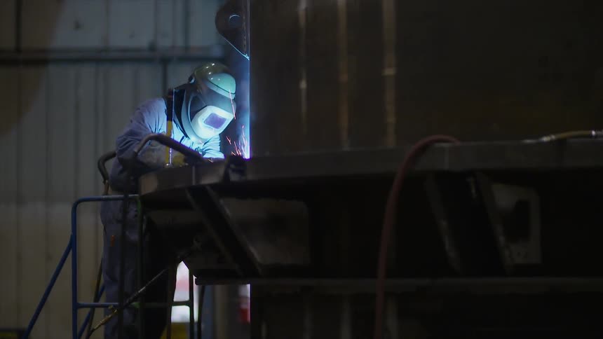A person is welding in a garage
