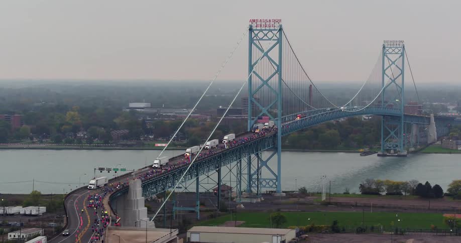 Many trucks travel over the large bridge