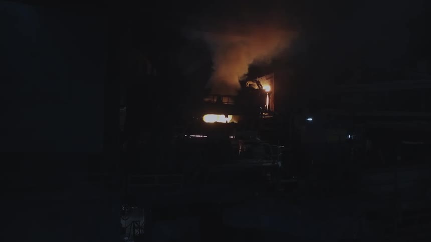 Smoke and fire billowing out of machines in a factory