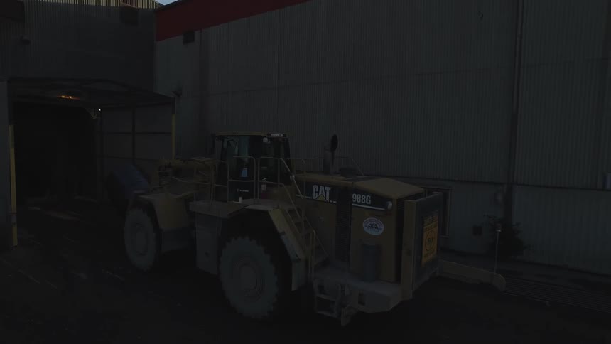 A construction vehicle exits a building