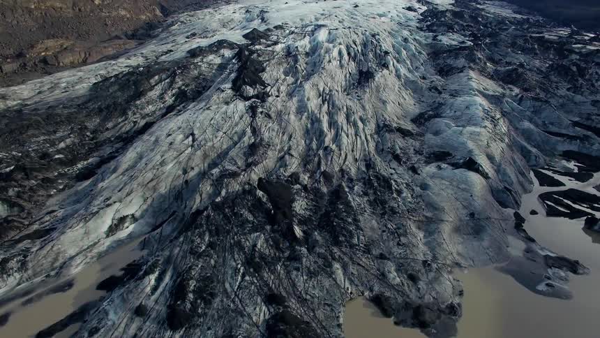 The mountain is covered with ice by the water