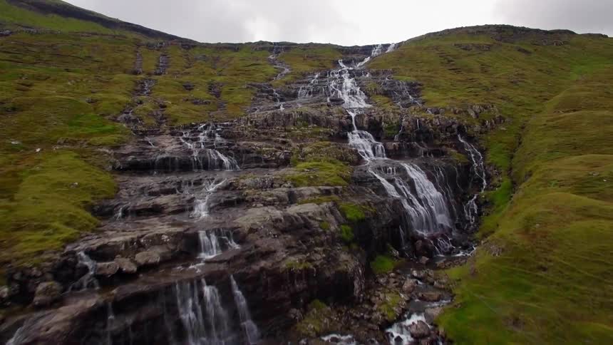 Water splashing down hills on a cloudy day