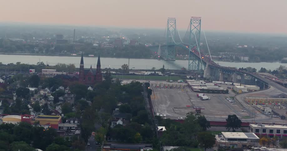 Cars travel over the bridge towards the city