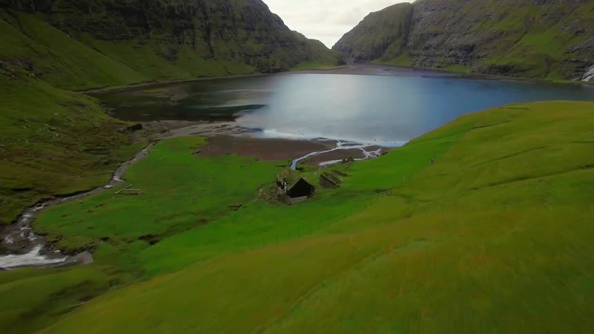 A mountain lake is shown in the summer