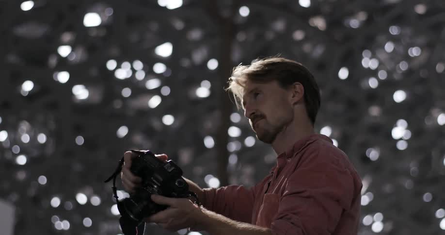 Man takes pictures under a holey structure