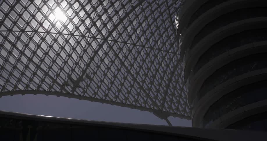 Sun shining through a fence as an airplane takes off