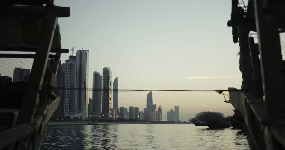 Across the water is a row of tall buildings