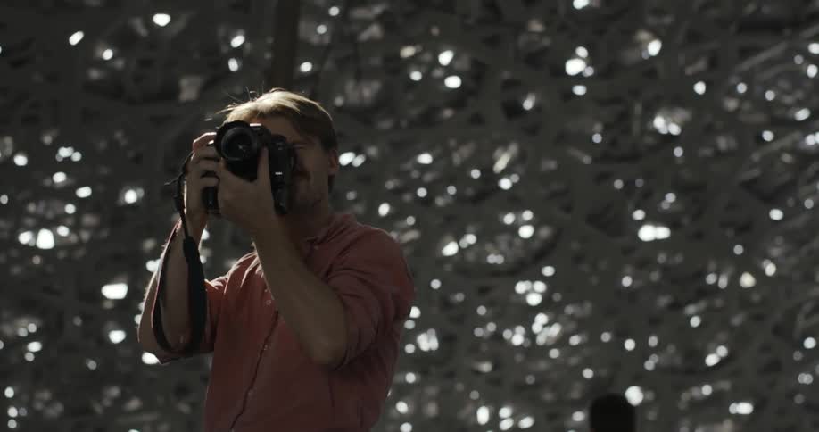 Man takes pictures under a holey structure