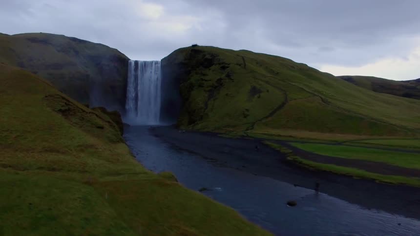 Waterfall splashes into a river