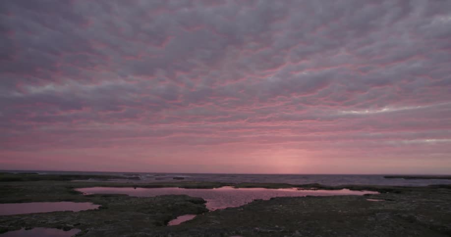 The setting sun is reflecting off the heavy clouds