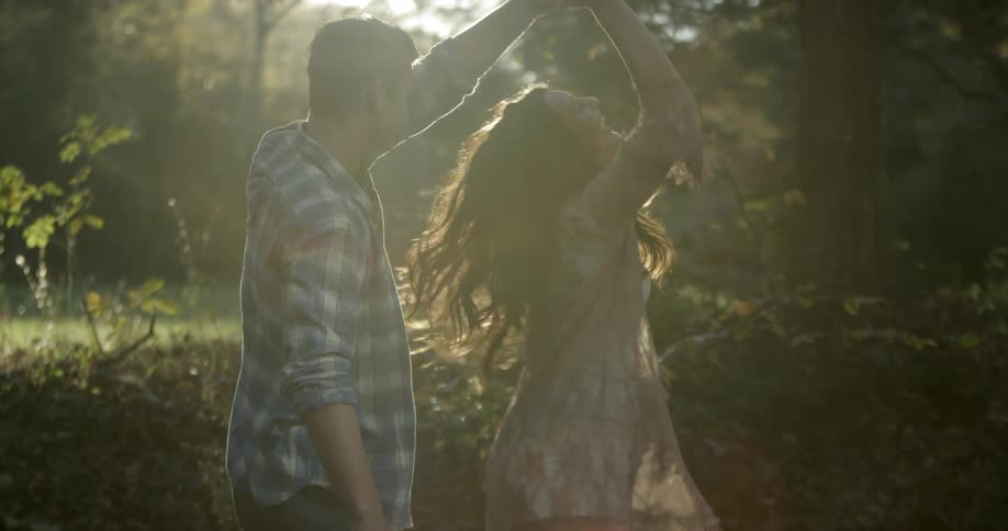 A man and woman dance and laugh