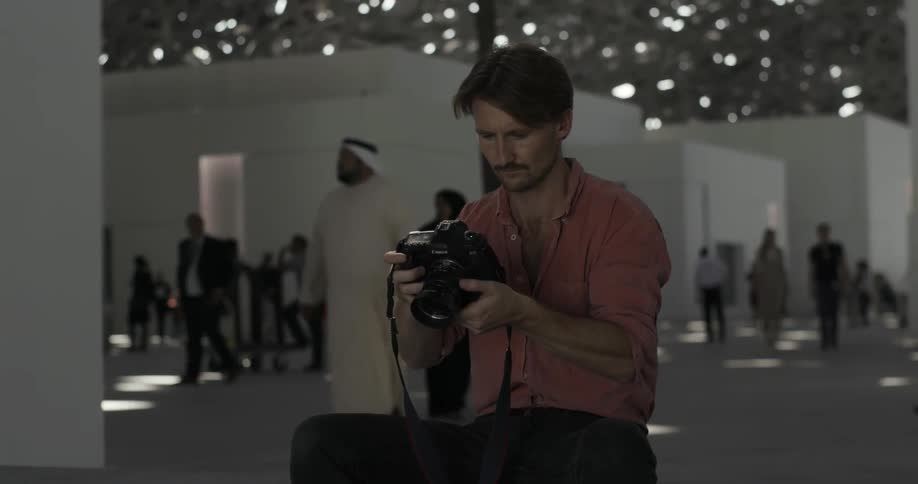 Man sits and takes pictures in a temple