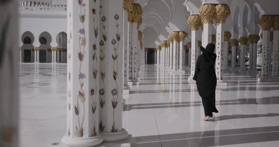 A person in dark robes is walking