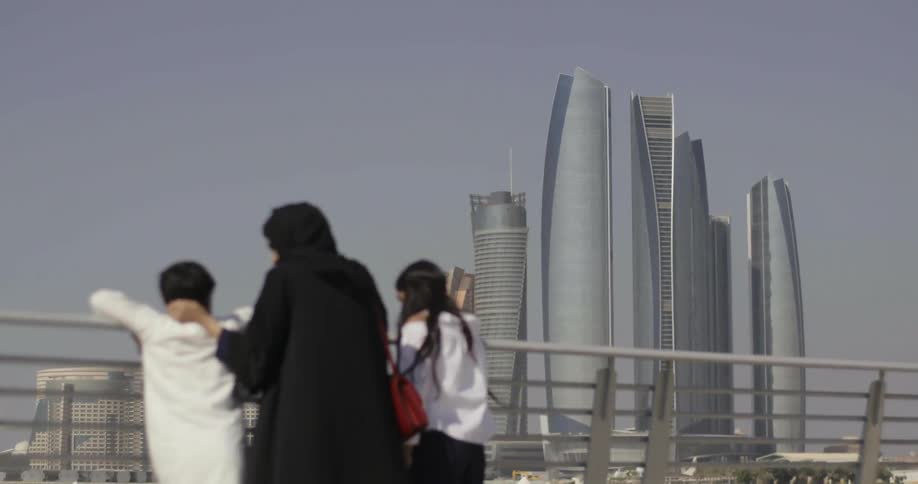 A family looks at city skyscrapers on a sunny day