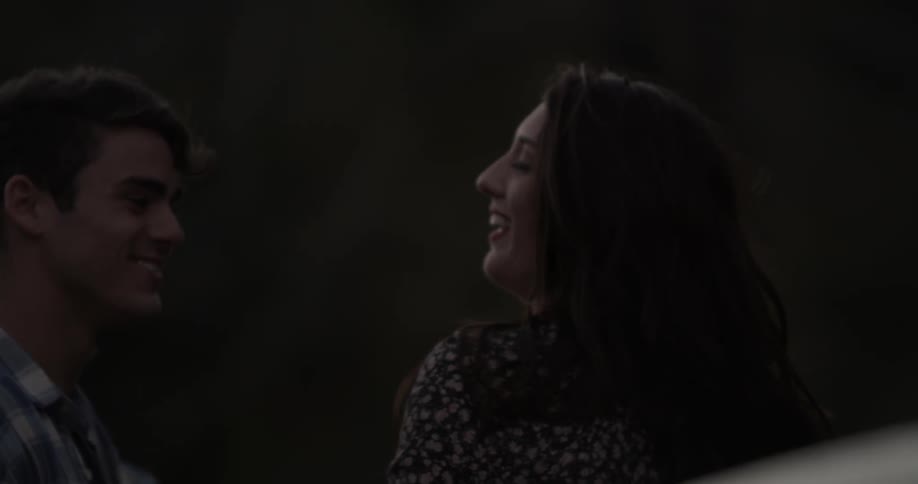 A man and woman dance outside