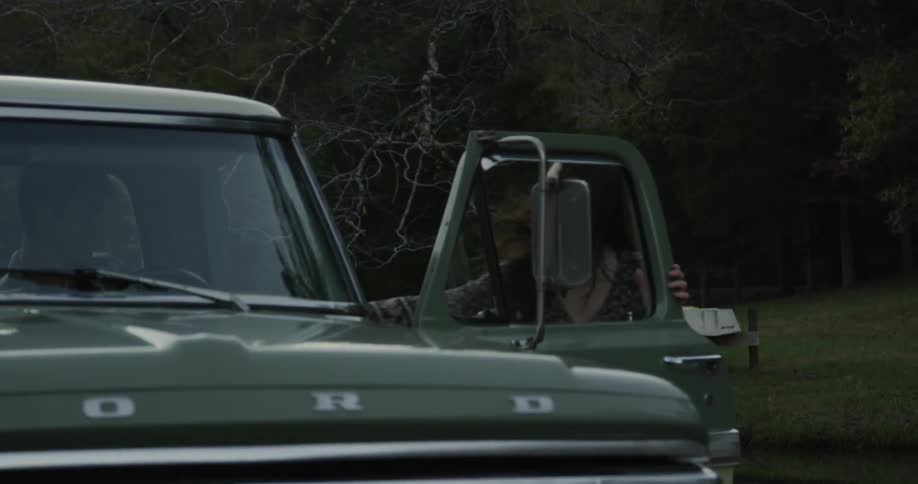 Woman opens door of truck and pulls man out