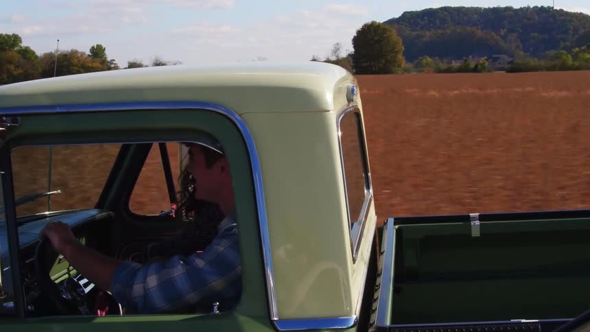 People are riding in a yellow pickup truck