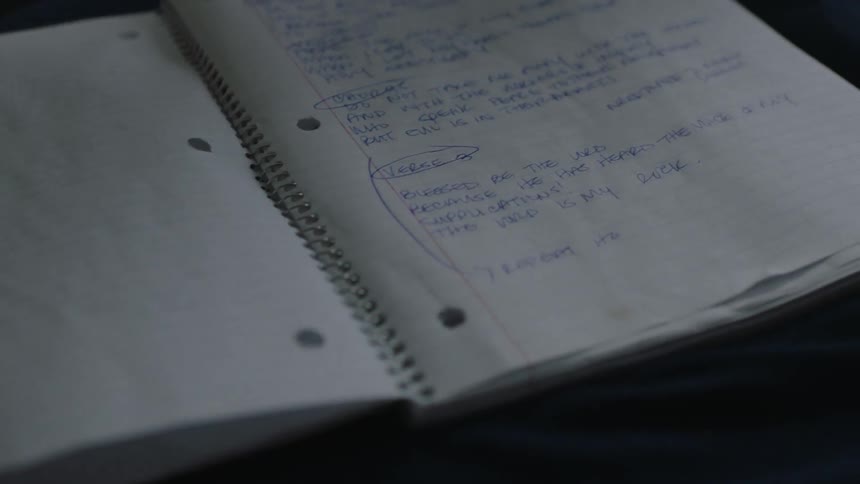 Someone turns the pages of a notebook