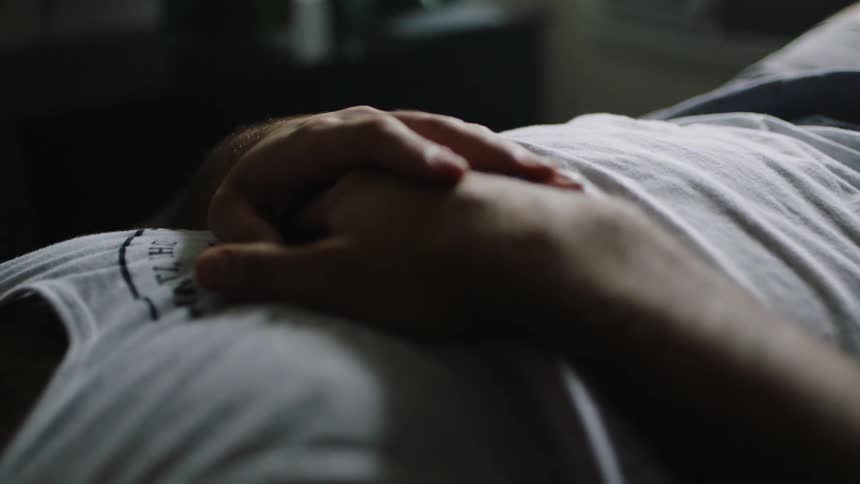 A man taps his hands on his chest