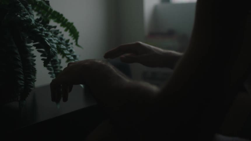 A man is tapping his counter in the dark