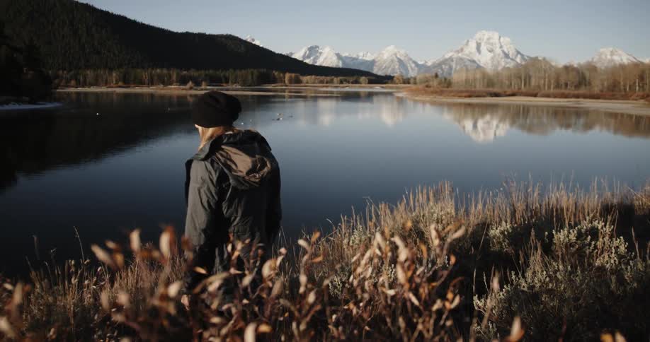 A woman hikes towards the lake