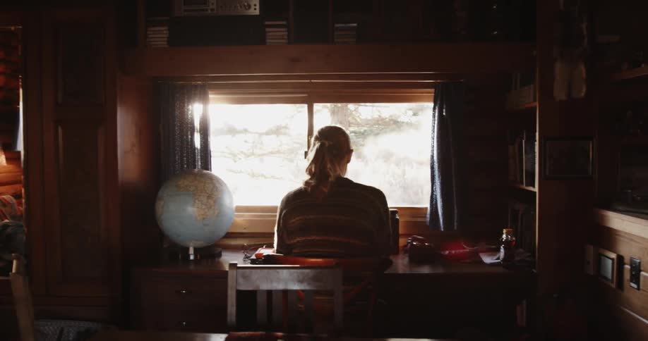 Woman sitting at a desk in front of a window