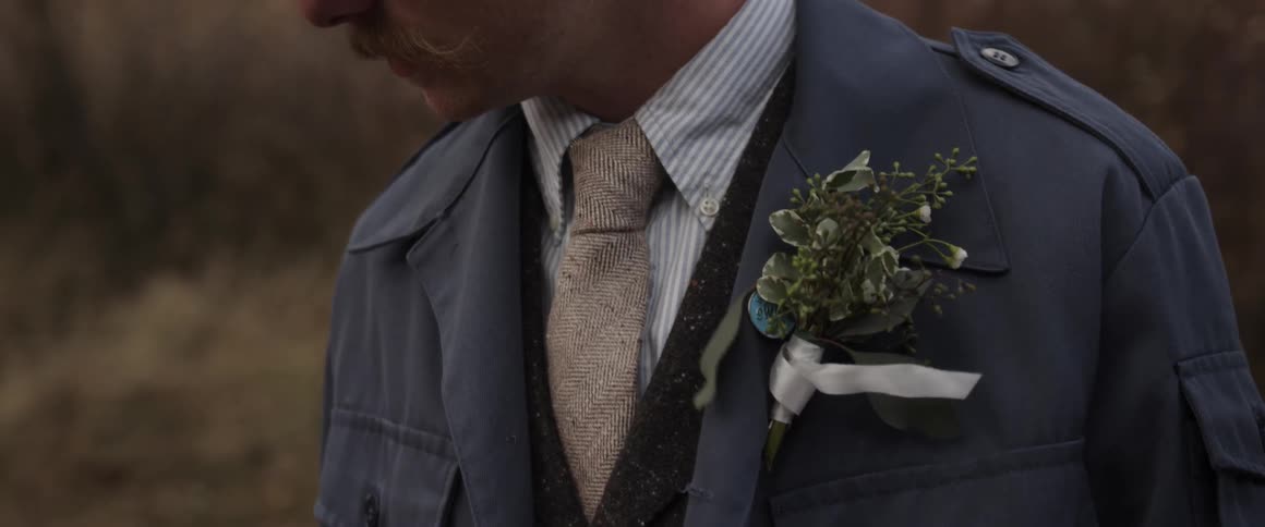 A man is wearing a suit on a windy day
