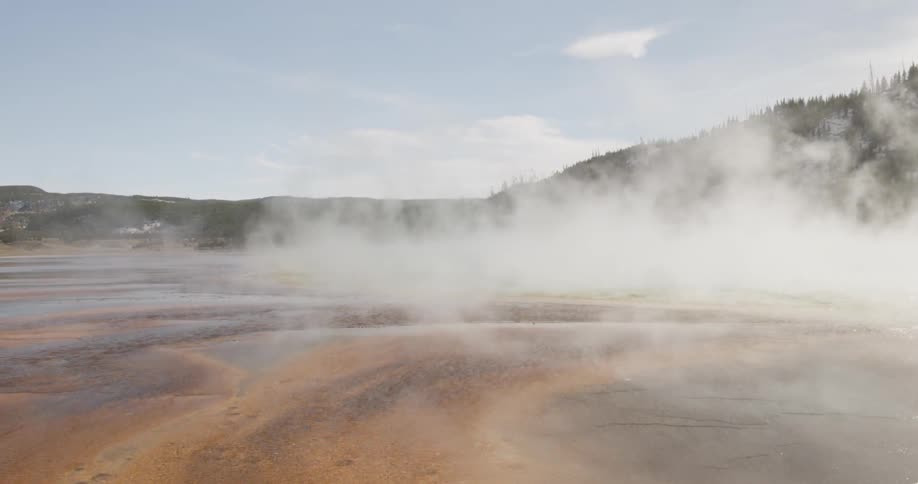 Fog rolls over a shallow body of water
