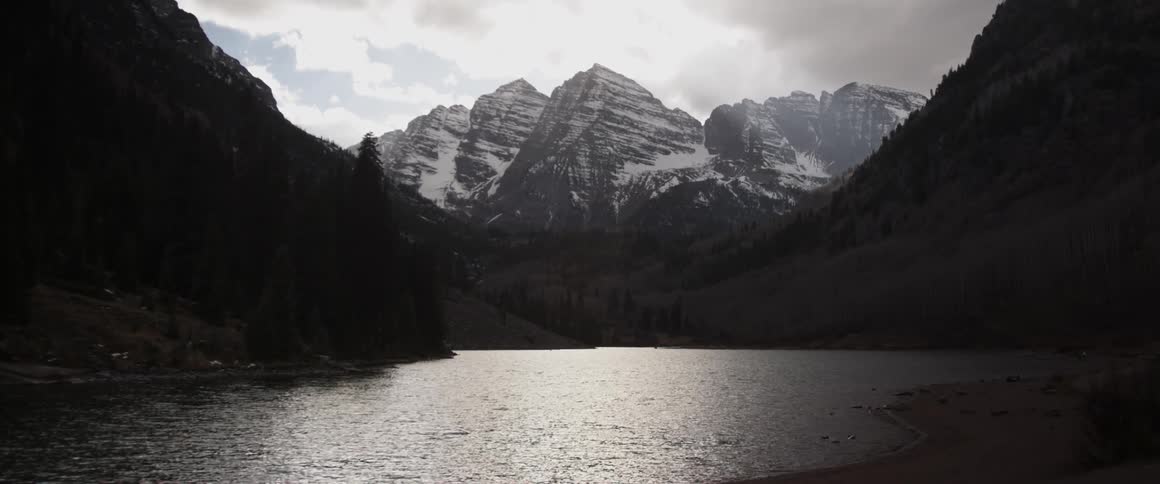 The ice covered mountain has a lake below