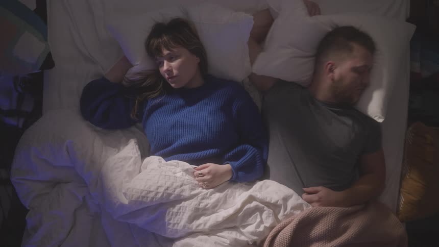 Man and woman lay in bed together