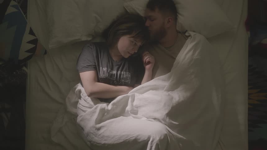 Man and woman lay in bed together