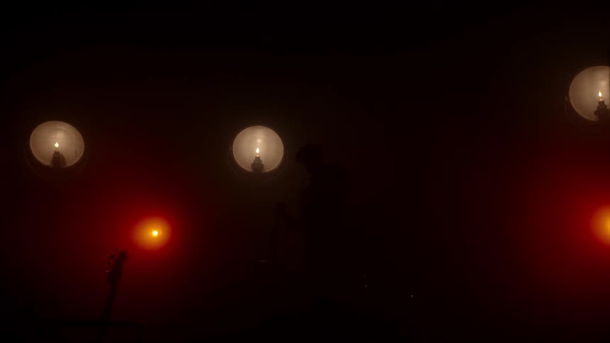Lights by candle and a guitar silhouette