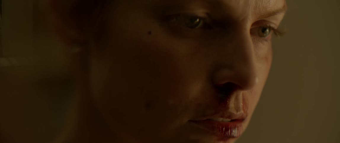 A woman has blood on her lip and face