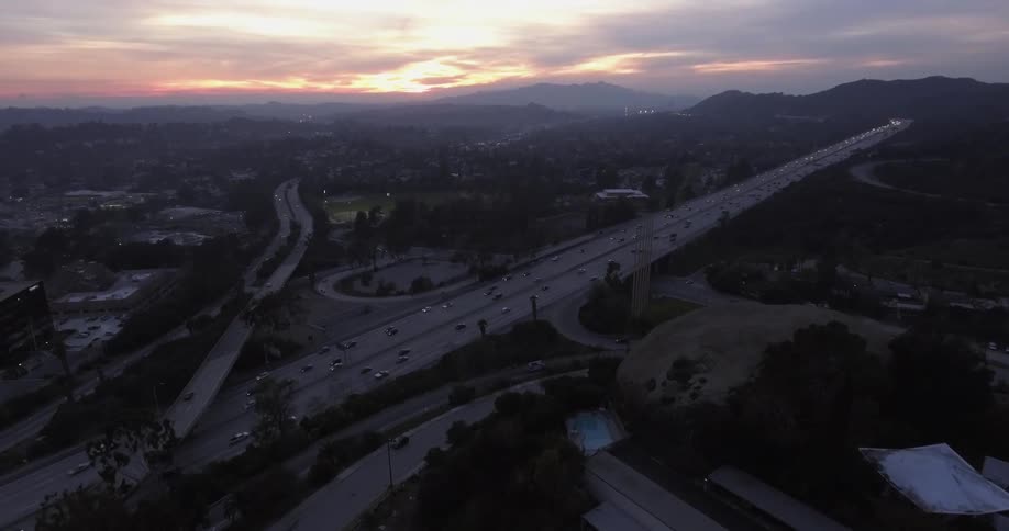 Traffic travels on a freeways at dusk