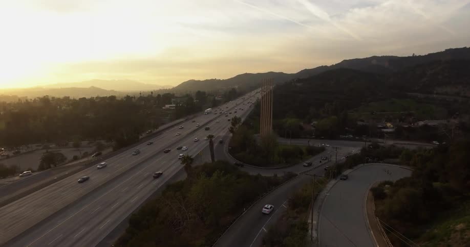 Traffic flows along a freeway and side streets at dawn