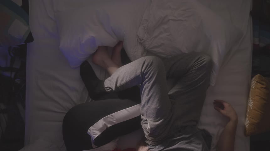 A man and woman lay in bed together