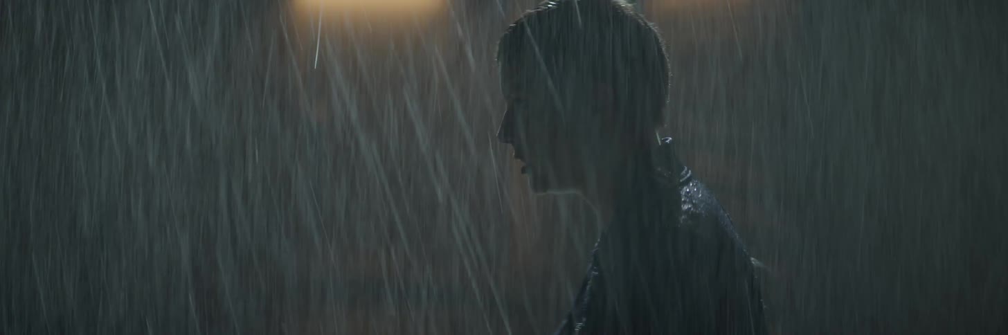 Angry woman stands outside in the rain
